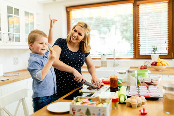 Happy mother and child in kitchen