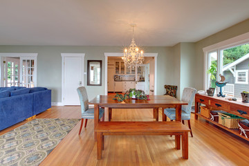 Cozy dining room interior with wooden table and hardwood floor.