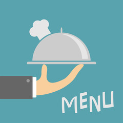 Waiter hand holding silver platter cloche with chefs hat. Menu card. Metal restaurant food cloche. Blue background. Flat design.
