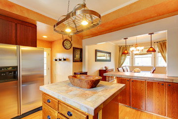 Kitchen and dining room interior with brown wooden cabinets and dining table set.