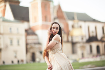 Girl in luxurious long dress on street of old town