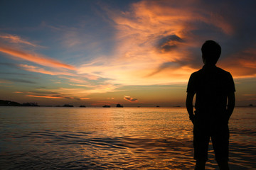 silhouette of man at sunset on the beach