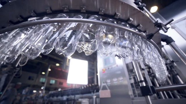 Modern clean Production line of carbonated drinks. Empty plastic bottles in automared washing line. HD.