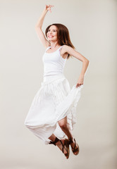 Woman in summer white dress jumping