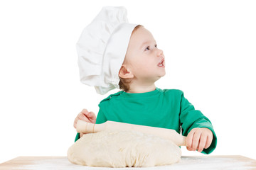 Smiling little boy kneading dough for the cookies, isolated on white