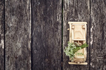 Wooden toy car with bouquet of wild flowers on a background of o