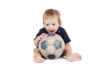 Baby boy playing with a soccer ball. Isolated on white 