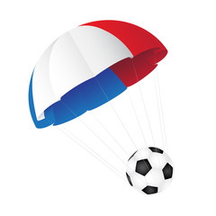 Parachute colored in the flag of France descends with a soccer b