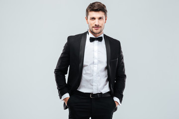 Fototapeta premium Confident young man in tuxedo with bowtie