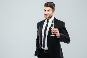 Businessman in suit and tie cheers with glass of champagne © Drobot Dean