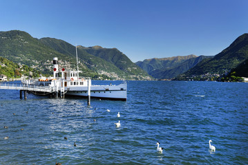Touristic boat at the pier in the small harbor of Lenno waiting for passengers, Lake Como, Italy, September 2015 