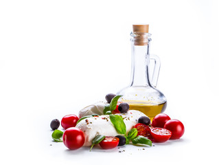 Caprese. Caprese salad. Italian salad. Mediterranean salad. Italian cuisine. Mediterranean cuisine. Tomato mozzarella basil leaves black olives and olive oil over white. Recipe - Ingredients