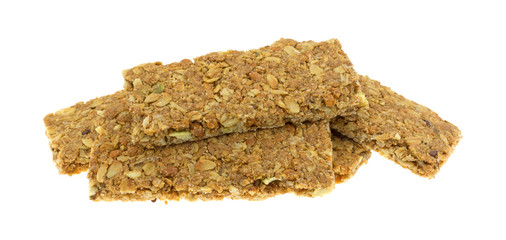 Several cinnamon sesame seed and pumpkin seed granola bars isolated on a white background side view.