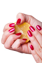 Hand with manicured nails squeeze lemon on white
