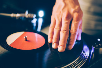 turntable scratch, hand of dj on the vinyl record