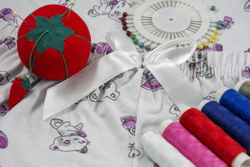 Several sewing tools are on the textile
