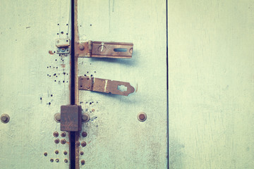 Rusty bolt on blue wooden door (vintage style)