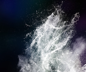 Water splash and powder on black background