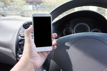 Hand hold blank screen smartphone inside car at driver seat,cellphone or mobile phone in hand in the car