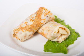 Stuffed pancakes on white plate