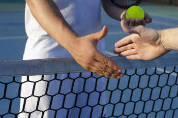 Tennis players shaking hands on the net, fair play, outdoors - obrazy, fototapety, plakaty