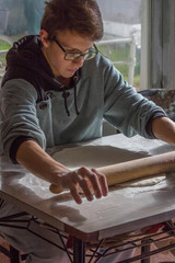 Man kneading pizza dough