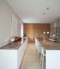 Modern house,minimal kitchen. Nobody inside. Kitchen and dining room together. It looks like a big hallway