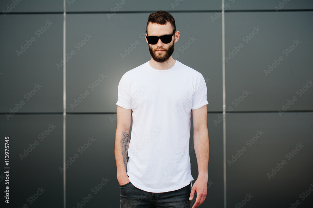 Wall mural Hipster wearing white blank t-shirt with space for your logo