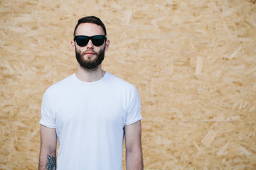 Hipster wearing white blank t-shirt with space for your logo