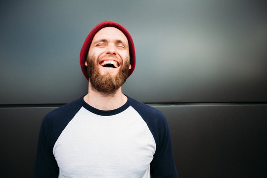 Hipster man smiling and wearing white blank t-shirt