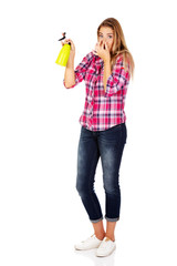 Young woman holding a watering spray bottle