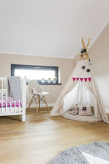 Child attic bedroom with a wigwam tent © Photographee.eu