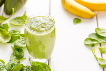 Absolutely Amazing Tasty Green Avocado Shake, Made with Fresh Avocados, Banana, Lemon Juice and Non Dairy Milk (Almond, Coconut) on Light White Wooden Background, Raw, Vegan Drink Conception, Close-up