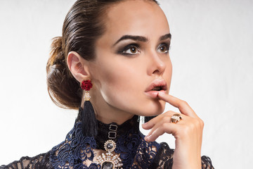 Fashionable girl with beautiful decorations on the arms and neck