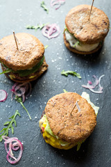 Three Different Tasty Big Burgers on Dark Stone Background, Top View