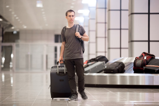 Young man got luggage at conveyor belt