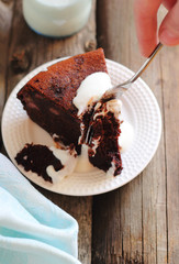 cutting a piece of chocolate cake with a banana garnished with y