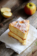 Two pieces of apple pie on a wooden background