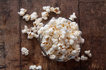 A bowl of popcorn on a wooden table