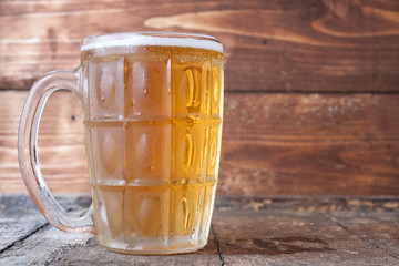 Beer mug on rustic wooden table