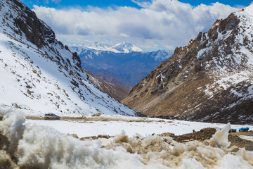 Car at Chang La pass with snow during spring season. Leh, Ladakh