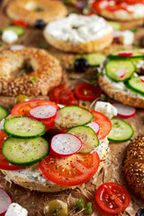 Delicious Bagel sandwiches with soft cheese, chorizo, vegetables. selected focus
