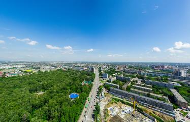 Aerial city view with crossroads and roads, houses, buildings, parks and parking lots, bridges. Urban landscape. Copter shot. Panoramic image.