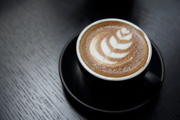 cappuccino coffee on wood background