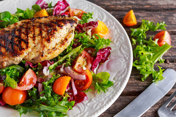 Grilled Chicken Breast fillet with fresh tomatoes vegetables salad. concept healthy food.