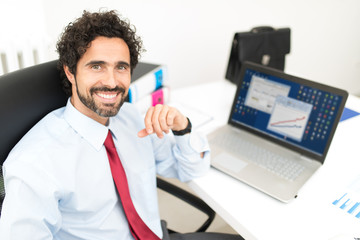 Smiling businessman in his office