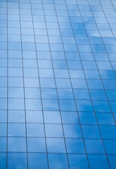 Reflection of blue sky on window glass office building