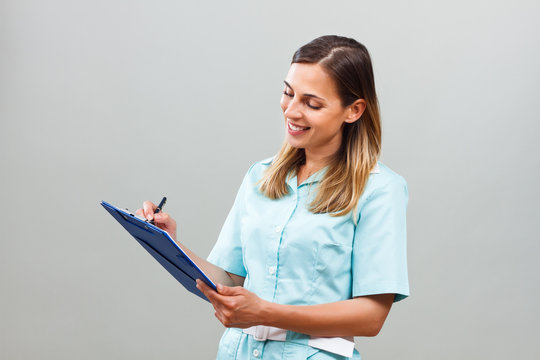 Beautiful Nurse Writing Notes.