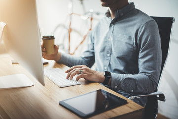 Professional businessman working at his modern office on computer, vintage bicycle in the blurred...
