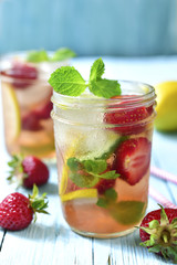 Strawberry lemonade with lemon and mint in a mason jar.
